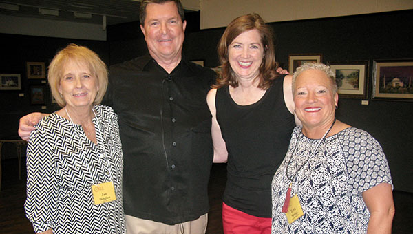 Larry Hess with OLLI at TTU, Lubbock members and volunteers Larry Hess stands in-between three OLLI members who all face the camera and smile.
