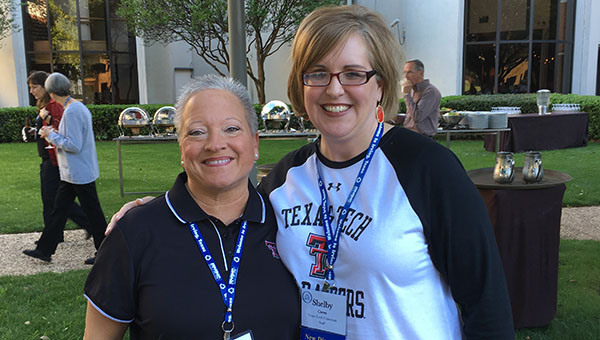 Terri Navrkal stands outside and hugs Shelby while both smile at the camera.