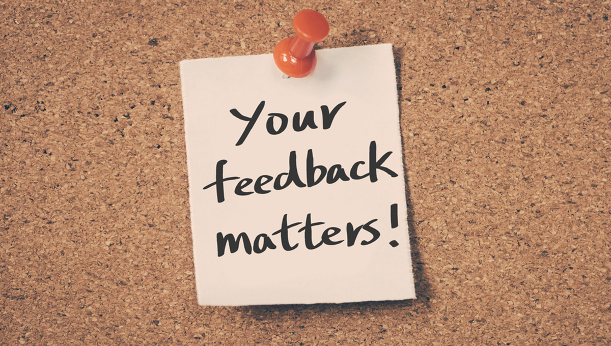 Your feedback matters A stock photo of a sticky note with the words 'Your feedback matters!' attached to a brown cork board by a red push pin