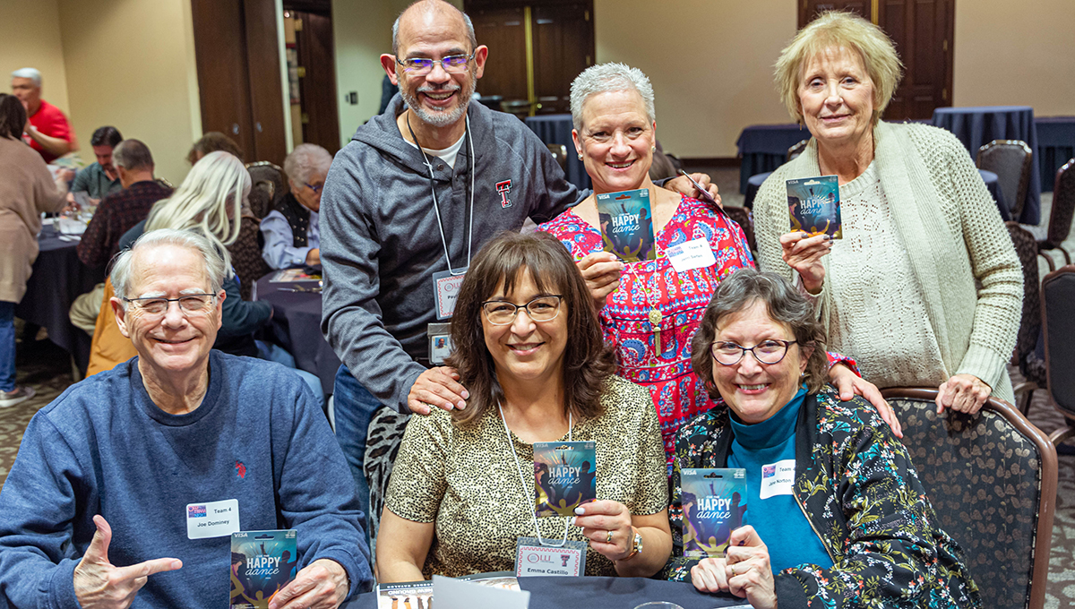 Trivia Night 1st Place team A man and two women sit and stare at the camera while smiling as another man and two other women stand behind them all while also smiling