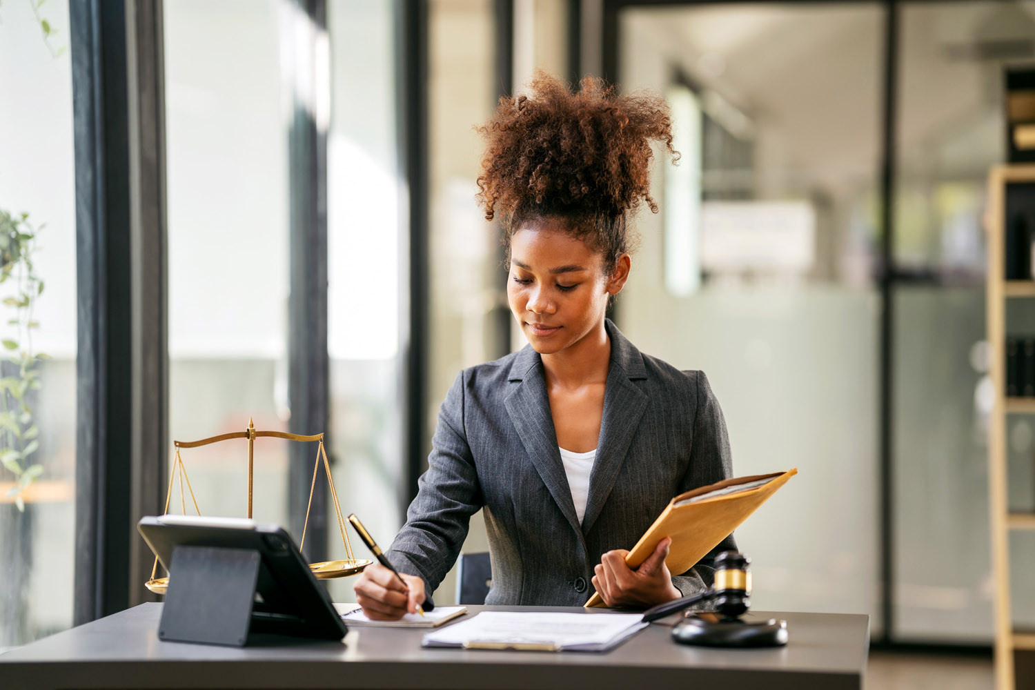 Lawyer sitting at desk in front of an Ipad