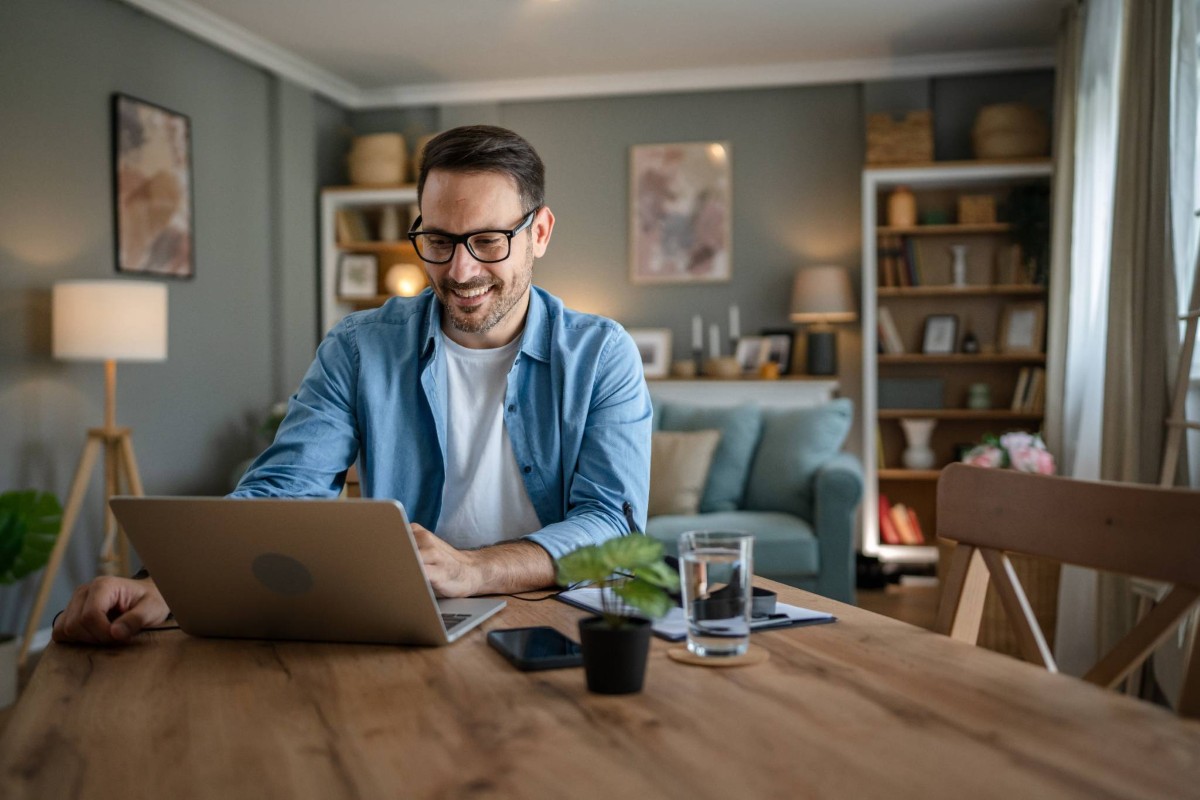 Man in front of lap top at home