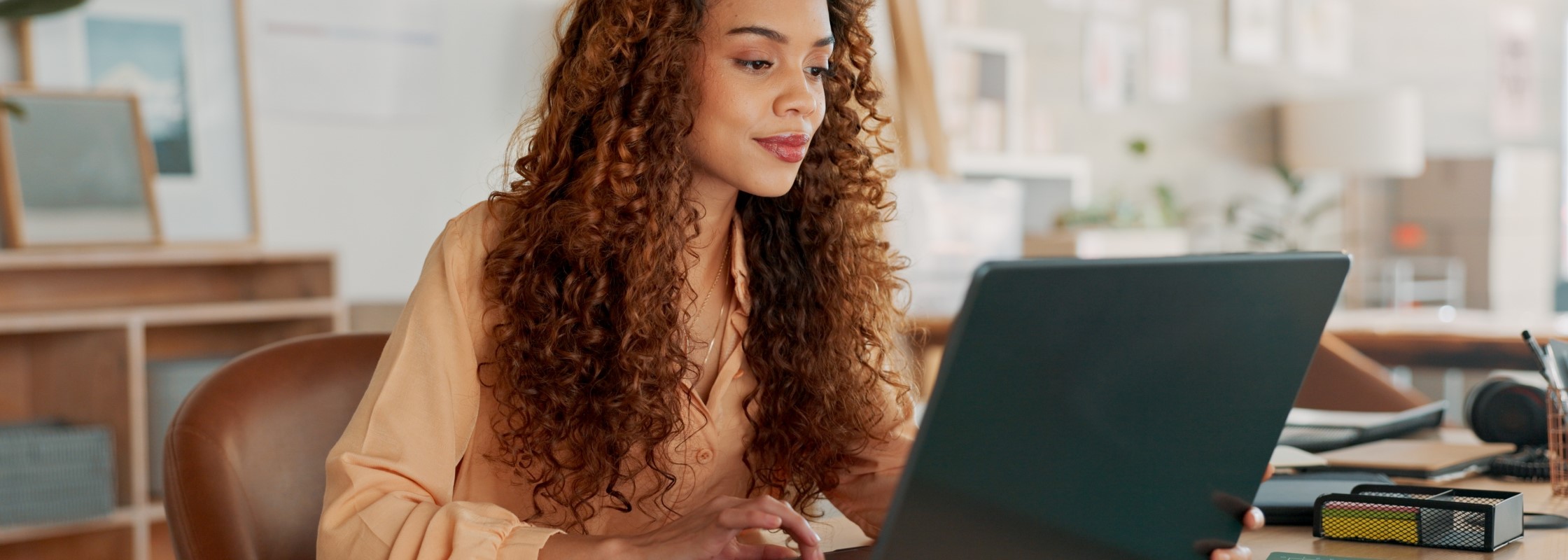 Photo of a woman on a laptop.