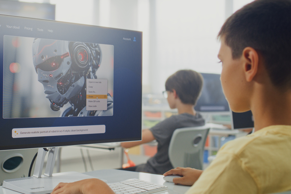 Student looking at a picture of an autonomous robot on a computer screen. 