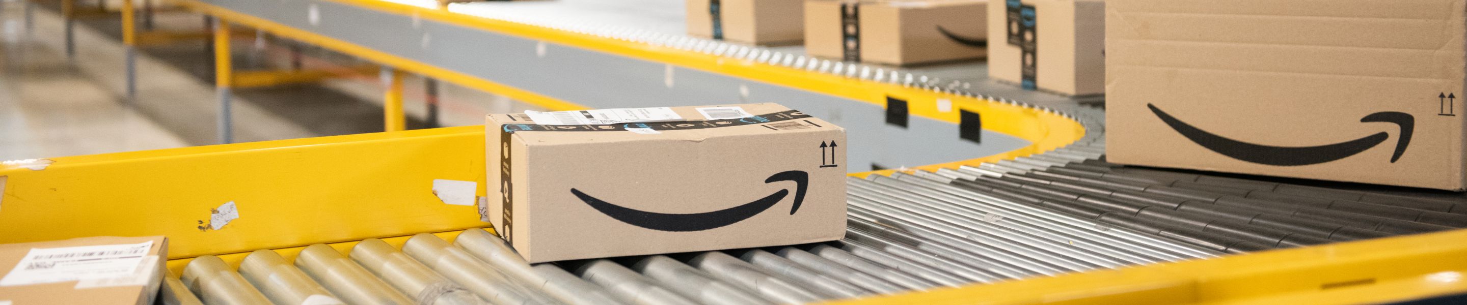 Amazon packages sitting on a conveyor belt.