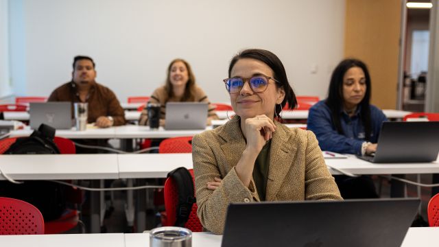 People sitting at desks with laptops open.