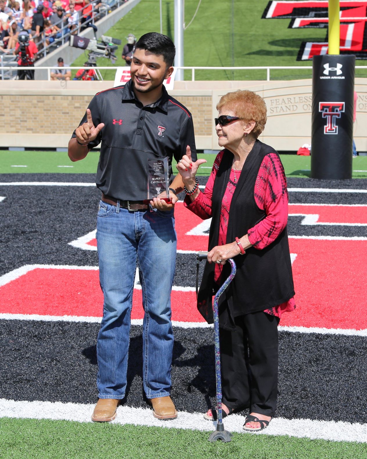 Grandparents of the Year awarded plaque during the Family Weekend football game