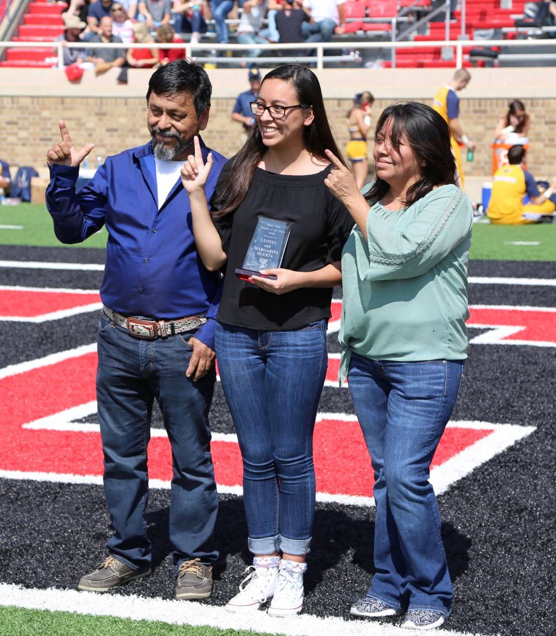 Parents of the Year awarded plaque during the Family Weekend football game