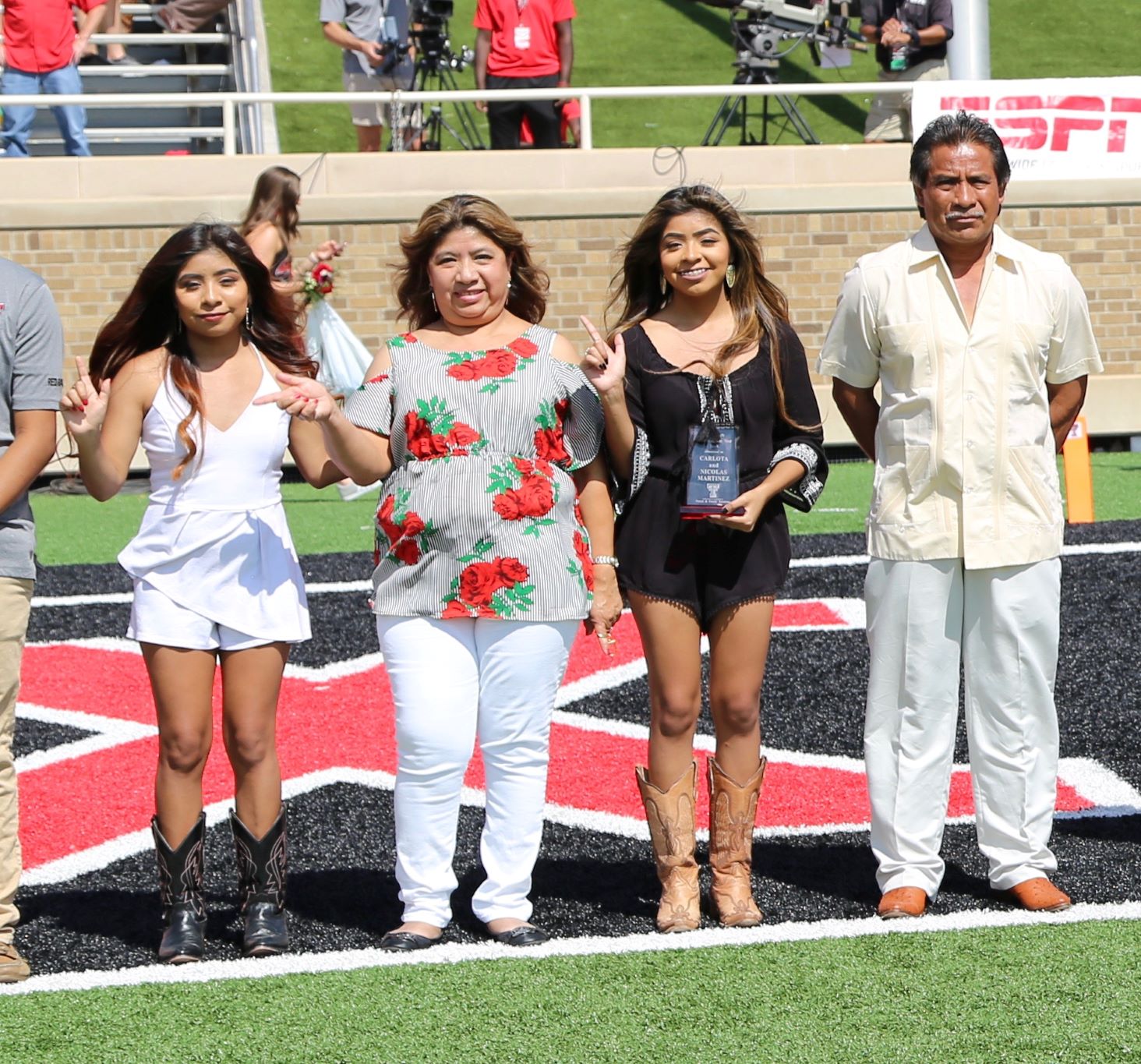 Parents of the Year awarded plaque during the Family Weekend football game