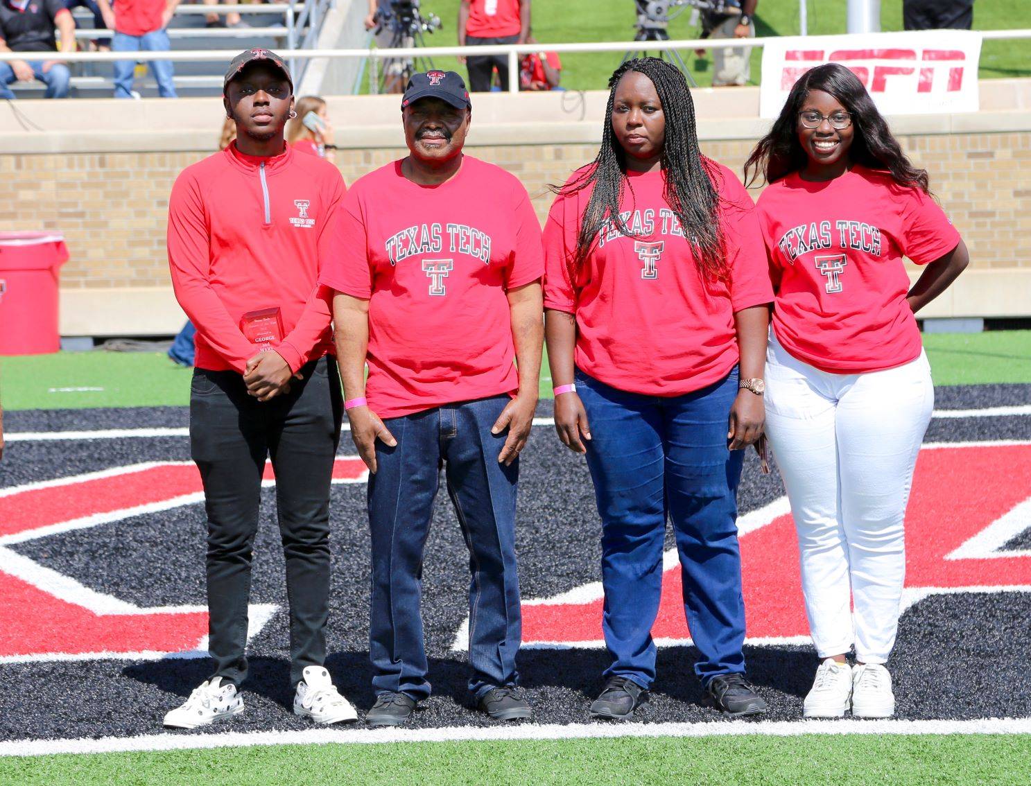 Parents of the Year awarded plaque during the Family Weekend football game