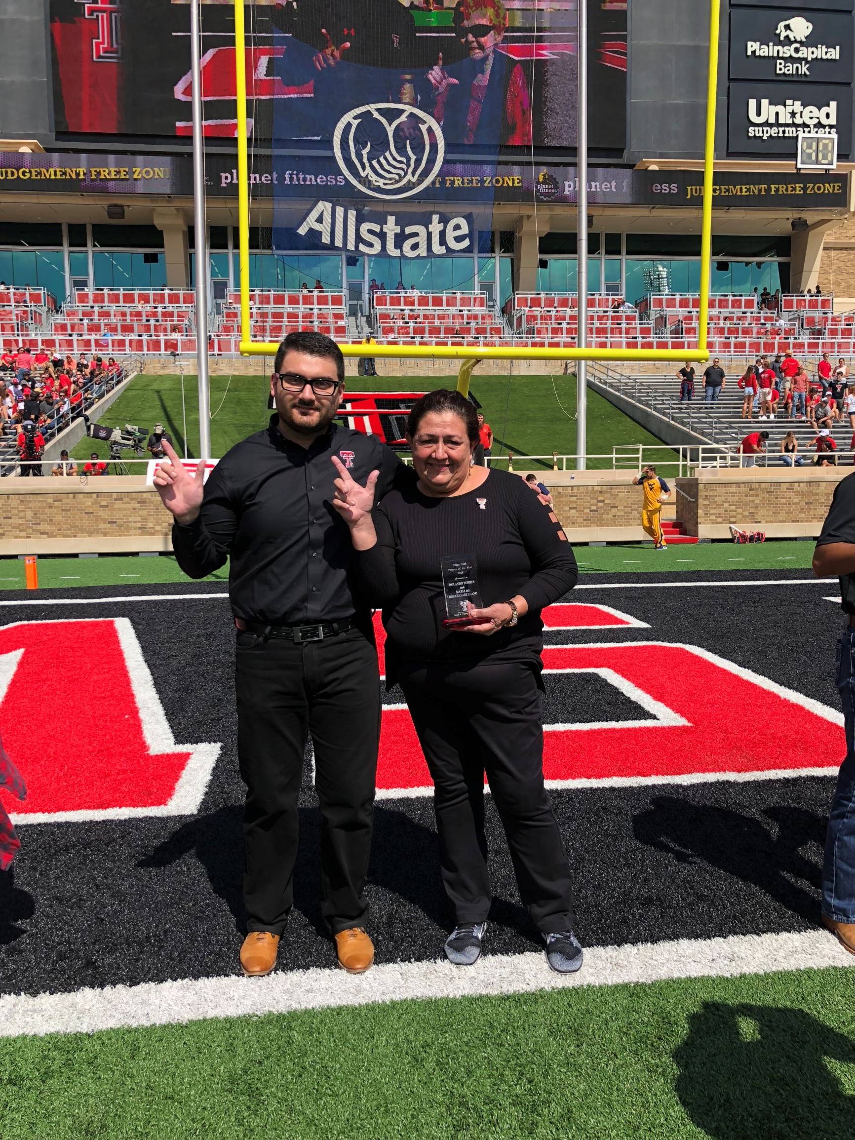 Parents of the Year awarded plaque during the Family Weekend football game