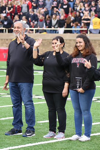 Parents of the Year awarded plaque during the Family Weekend football game