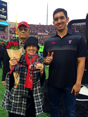 Grandparents of the Year awarded plaque during the Family Weekend football game