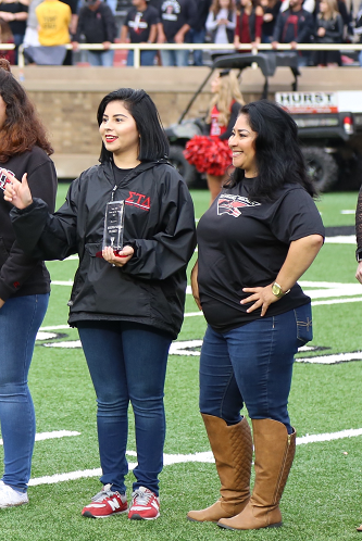 Parents of the Year awarded plaque during the Family Weekend football game