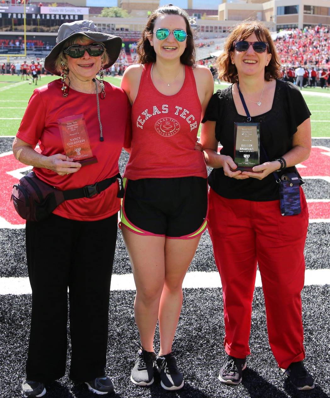 Grandparents of the Year awarded plaque during the Family Weekend football game