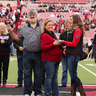 Parents of the Year awarded plaque during the Family Weekend football game