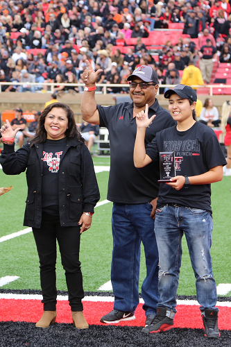 Grandparents of the Year awarded plaque during the Family Weekend football game