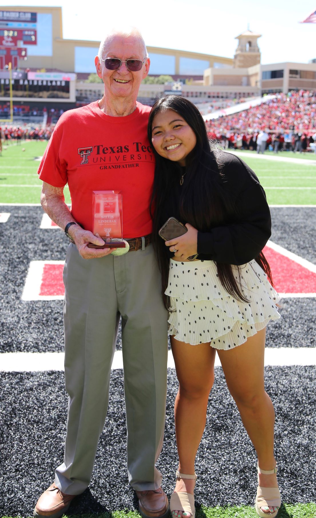 Grandparents of the Year awarded plaque during the Family Weekend football game
