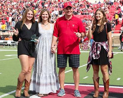 Parents of the Year awarded plaque during the Family Weekend football game