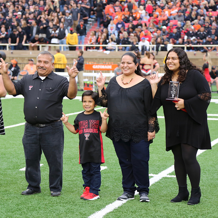 Parents of the Year awarded plaque during the Family Weekend football game