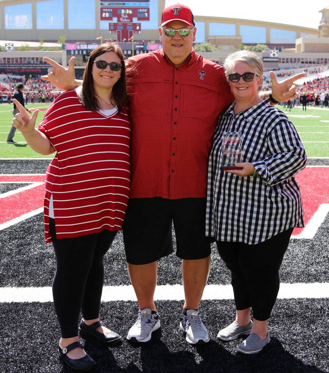 Parents of the Year awarded plaque during the Family Weekend football game