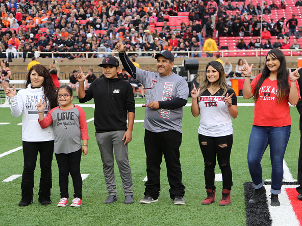 Parents of the Year awarded plaque during the Family Weekend football game