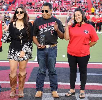 Parents of the Year awarded plaque during the Family Weekend football game