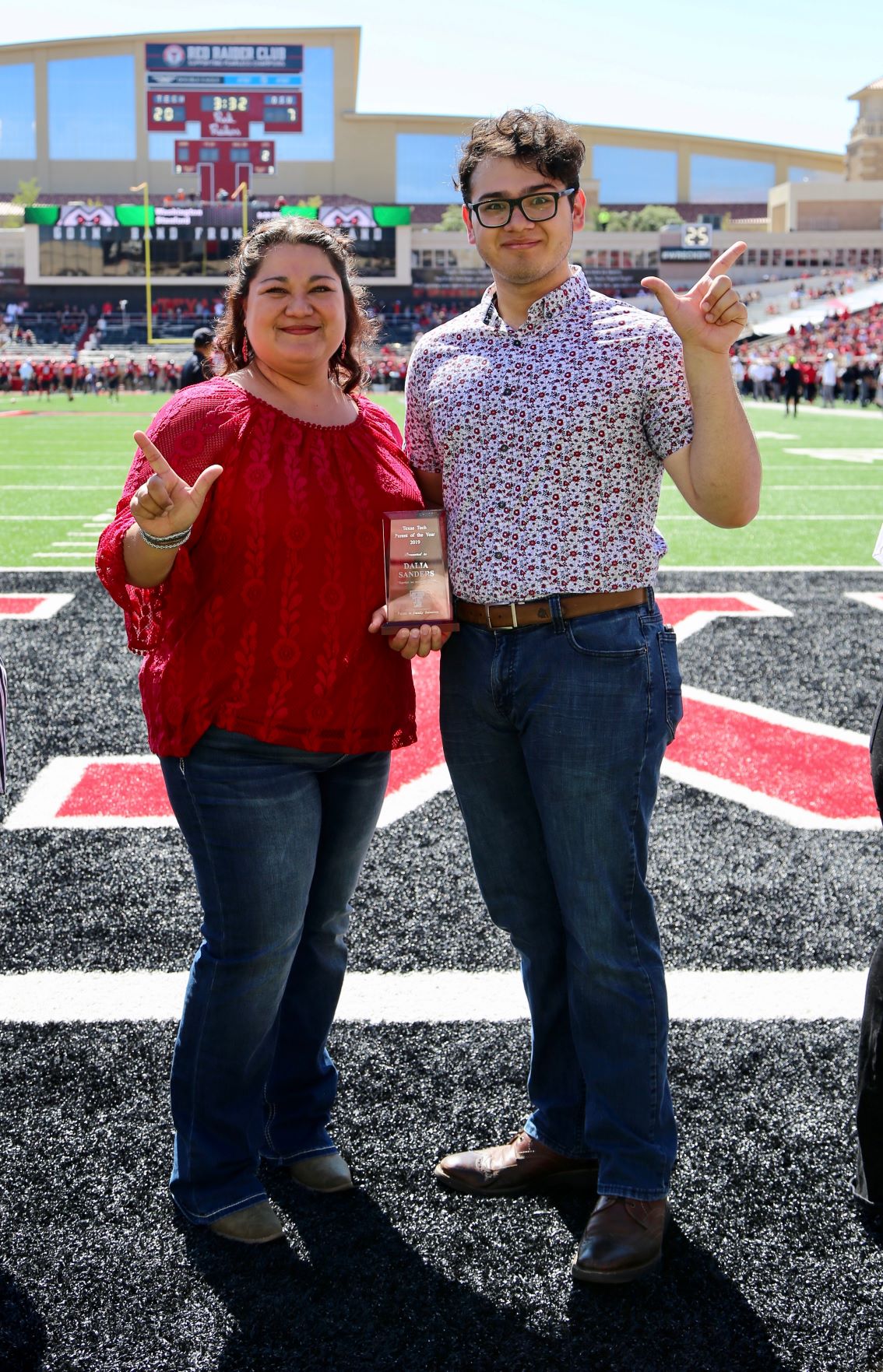 Parents of the Year awarded plaque during the Family Weekend football game