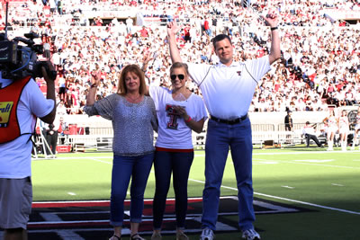 Parents of the Year awarded plaque during the Family Weekend football game