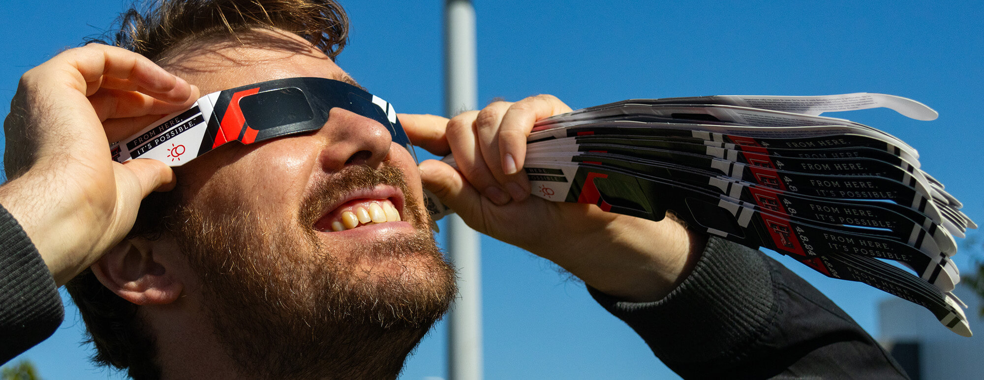 man using polarized spectacles to view a solar eclipse