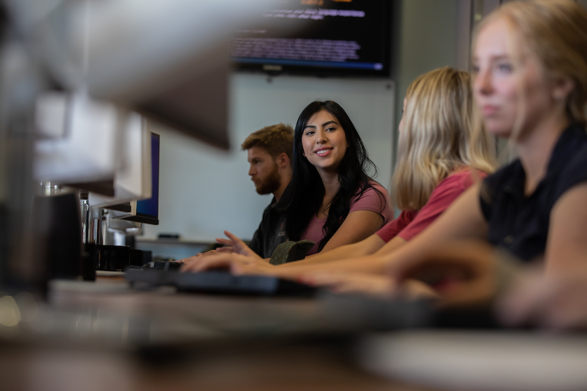 Image of instructor and smiling students.