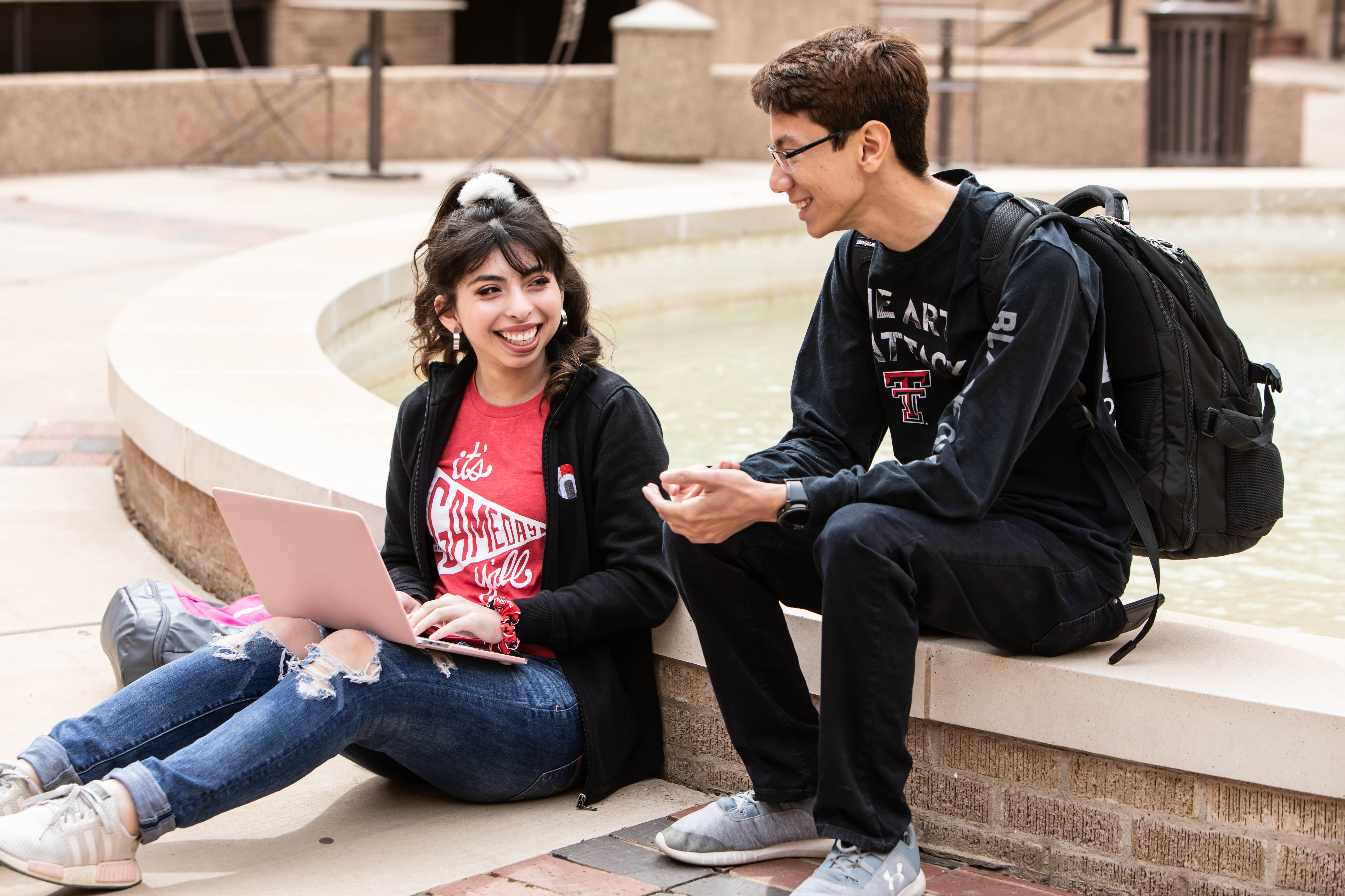 Image of students sitting by fountain