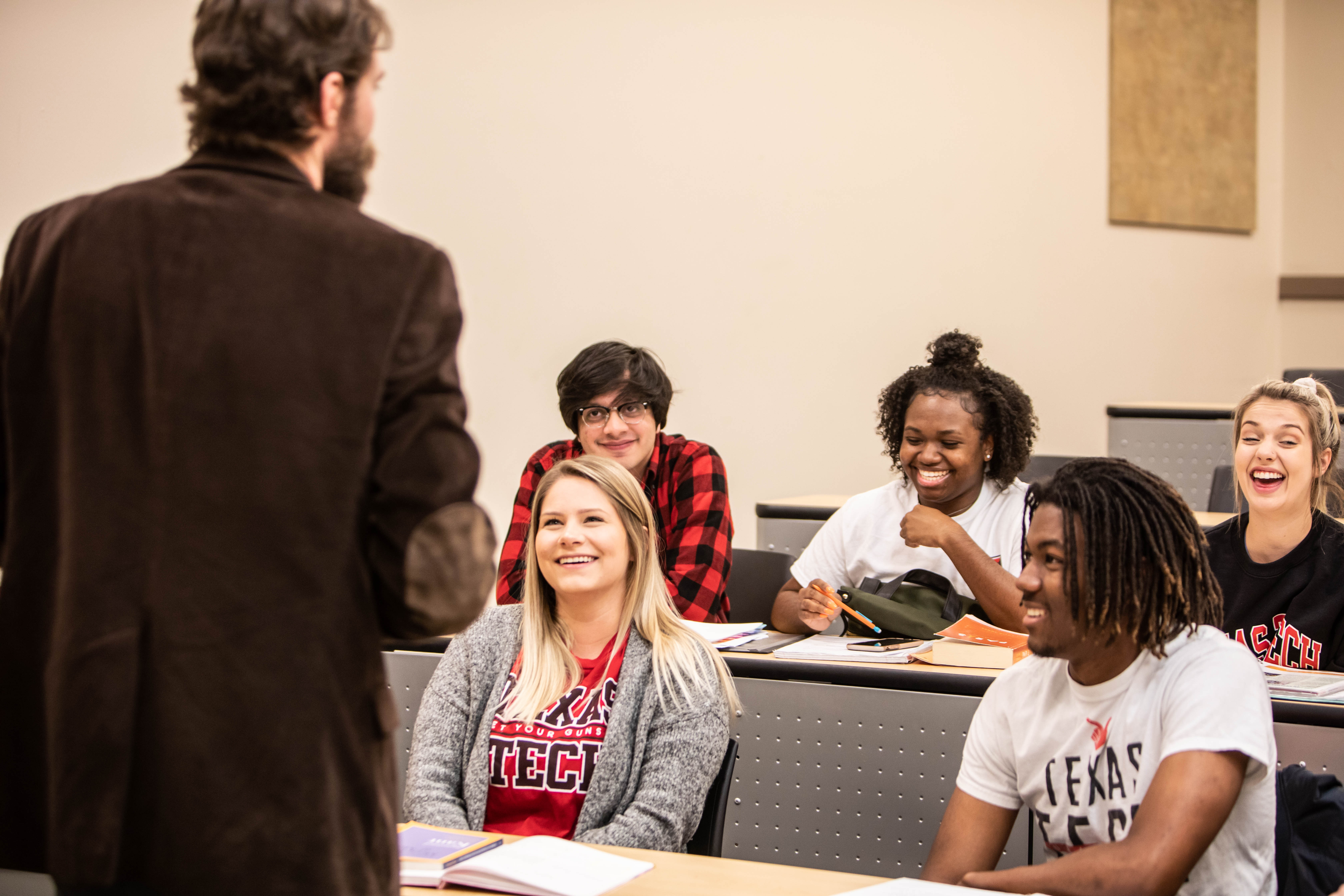 Image of instructor and smiling students.