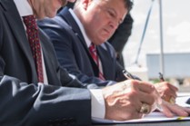 Image of people in suits with pens and papers