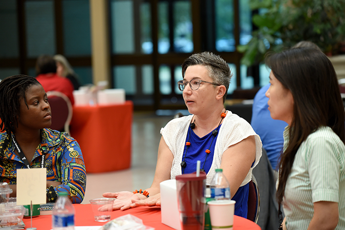 Faculty talking around a table