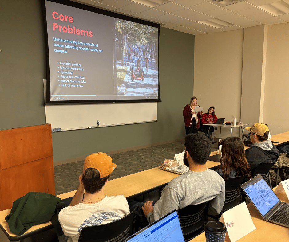 Students giving a presentation in front of a class