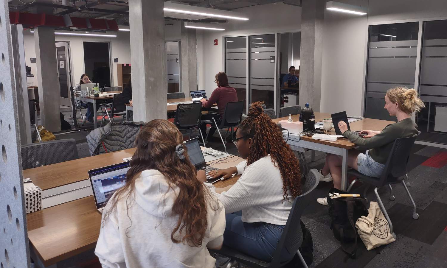 Image of the Undergraduate Writing Center in Weeks Hall with consultants and students hard at work.