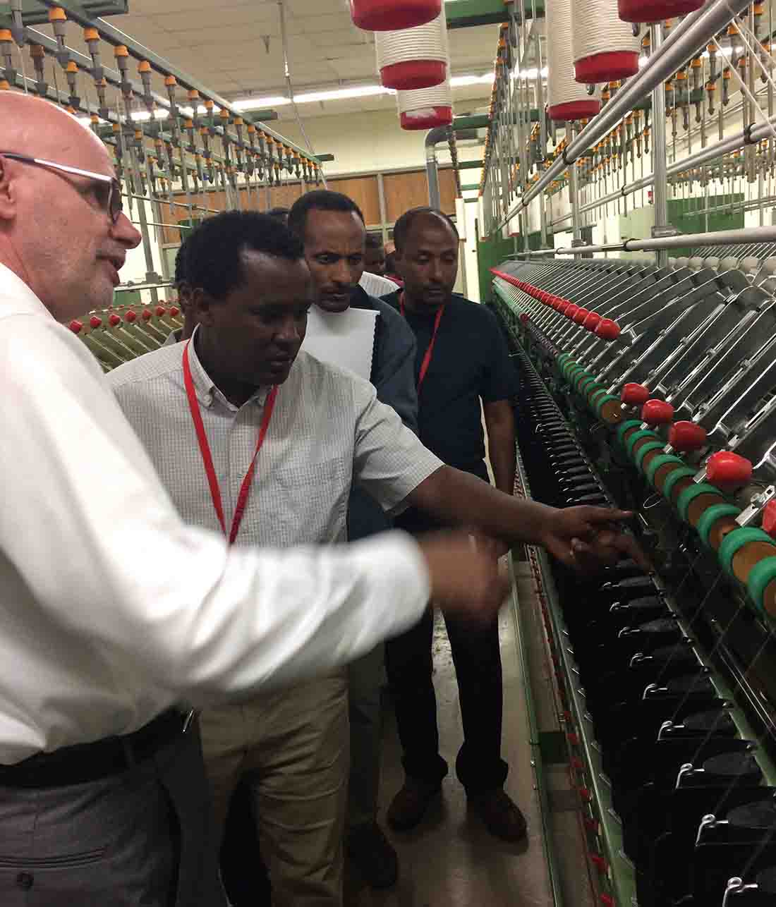 Eric Hequet leads a group from Ethiopia through the Spinning Lab of FBRI