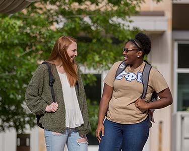 Two students smiling skew