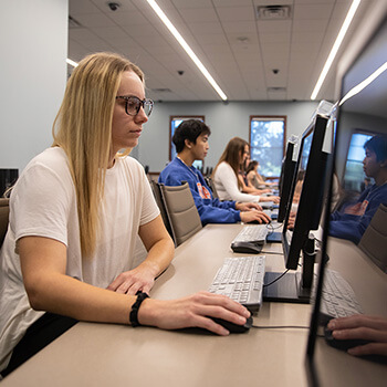 Girl with Glasses on Computer