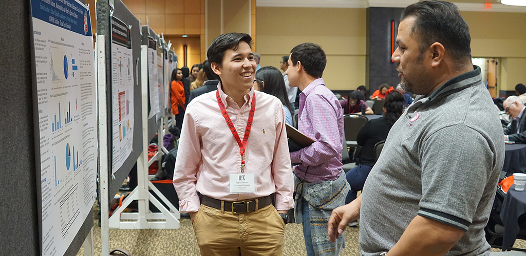 Student presenting project in front of man