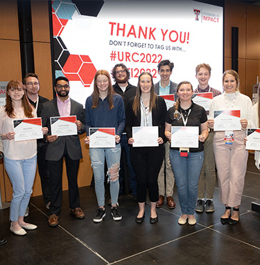 Group of students with diploma conference