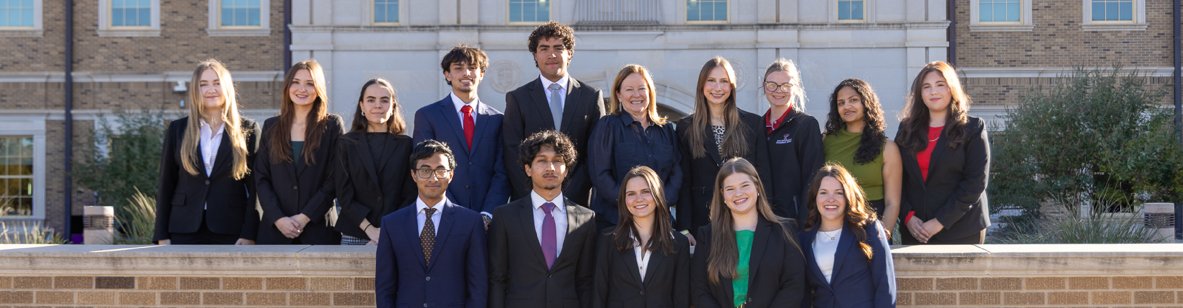 Photo of Dean's Student Council members in front of Rawls College building