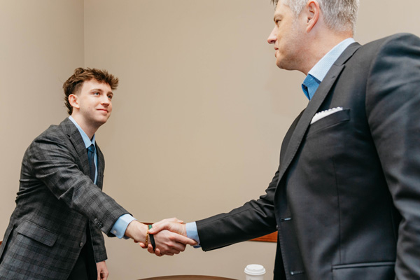 Student shakes hand with employer during an interview scheduled at the CMC