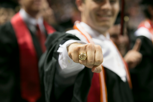 Student showing off graduation ring at commencement ceramony