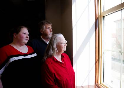 Collins family peers out Rawls College window