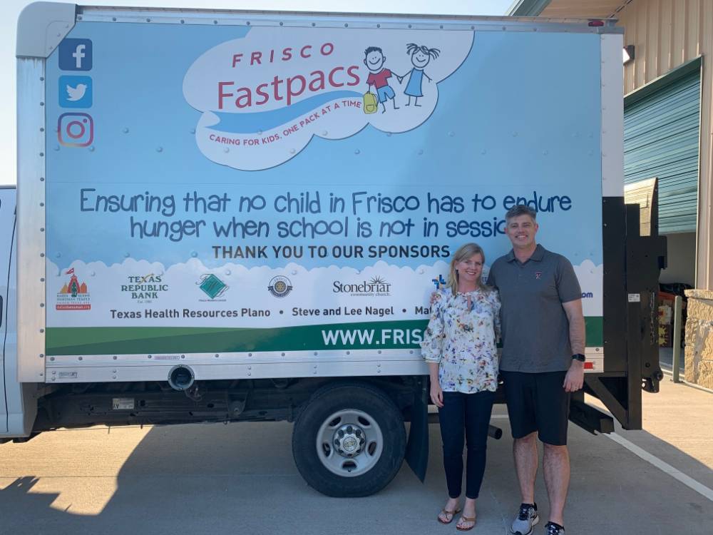 Matthew and Tracie Reiter by Frisco Fastpacs truck