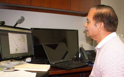 Professor Yadav viewing model on computer