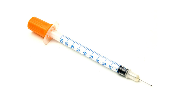 needle and syringe on white background