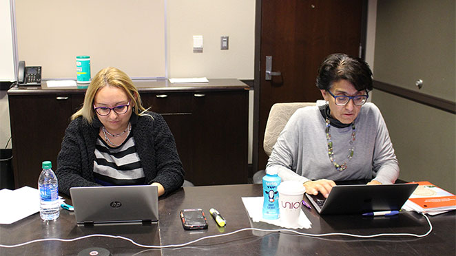 Paola Tiedemann, left, and Alice Villalobos work on research during a meeting of the Women Faculty Writing Program.